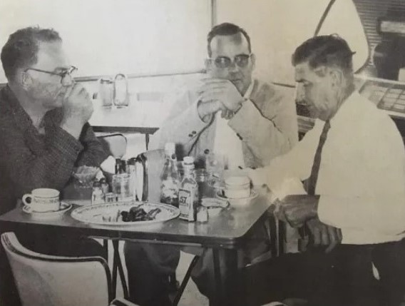 Bob Hemphill (in the left), Bob ONeal (center) and Gaboon Trahan (in the right) talking in a diner